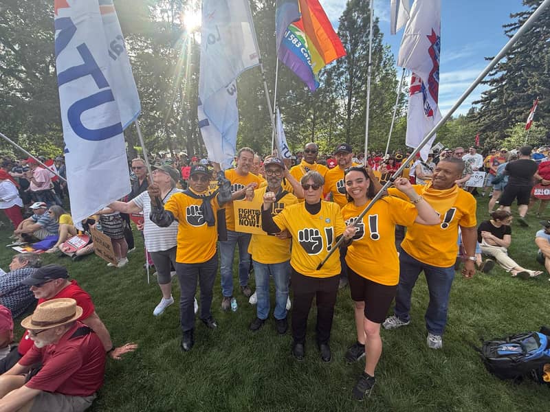 A volunteer crew, arms raised