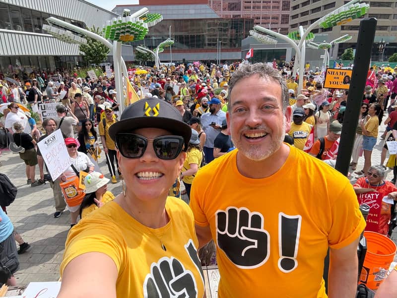 Two organizers above the Edmonton crowd