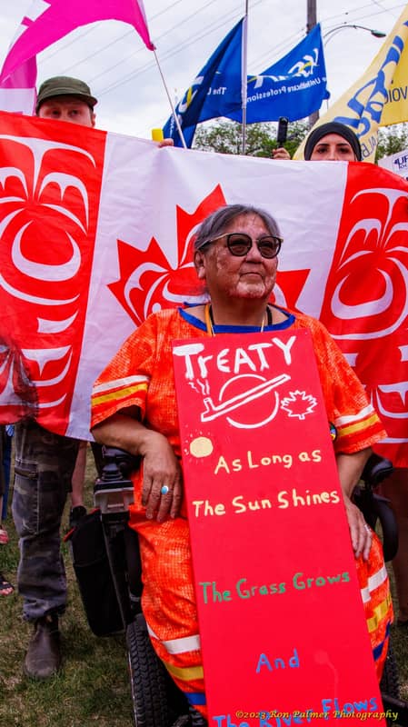 Elder holding a Treaty sign